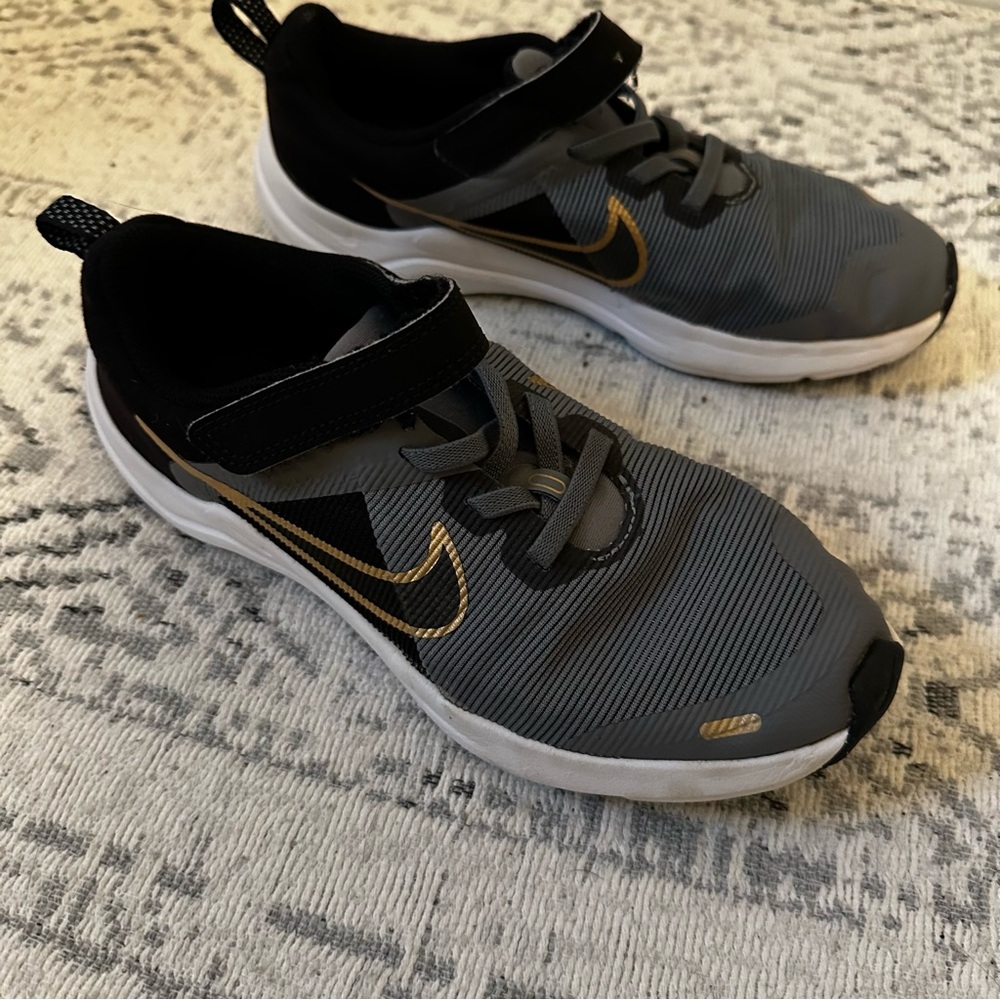 Nike Black and Gray Sneakers with Gold Swoosh